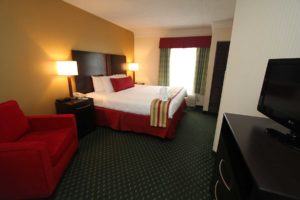 King bed in bedroom of suite at Black Bear Inn & Suites